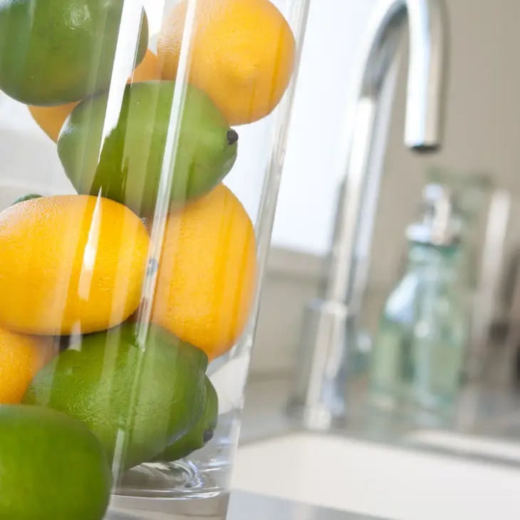 lemons and limes in kitchen jar