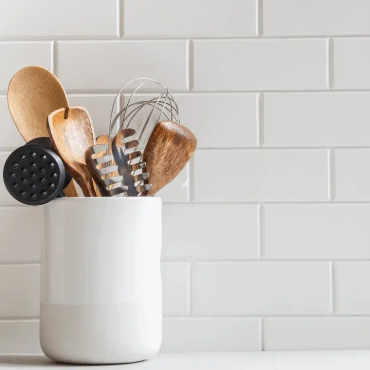 cooking utensils in jar on kitchen counter